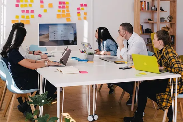  A team in an office discussing knowledge management during a meeting